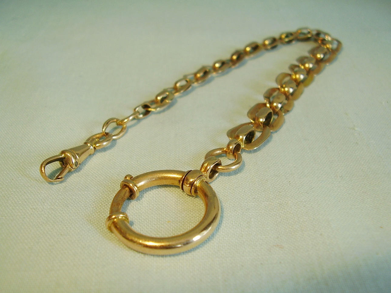 ANTIK KLOCKKEDJA I ROSÉGULD 333 ART DECO, KRING 1920.