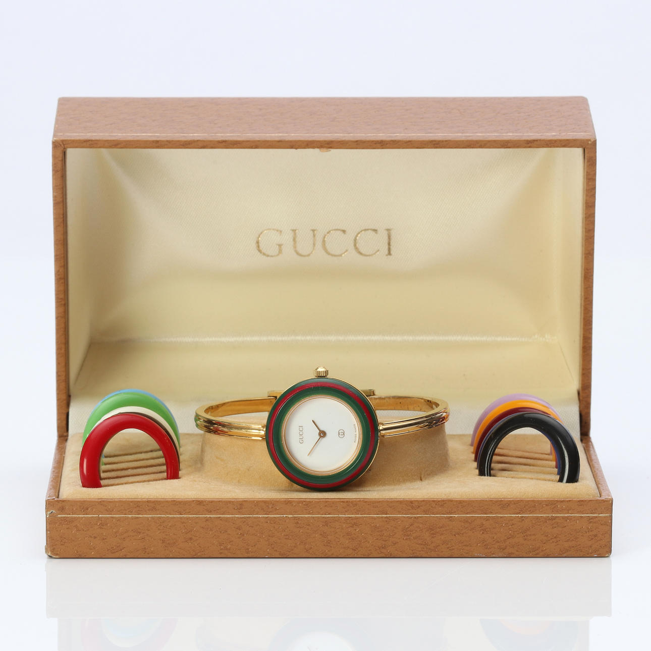 GUCCI, WRISTWATCH. Gold doublé with interchangeable rings in plastic, quartz.