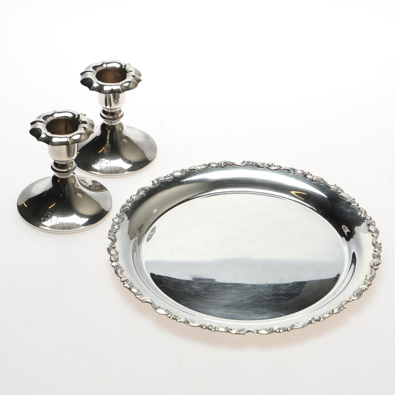 SAUCERS AND CANDLESTICKS. Silver, 3 pieces.