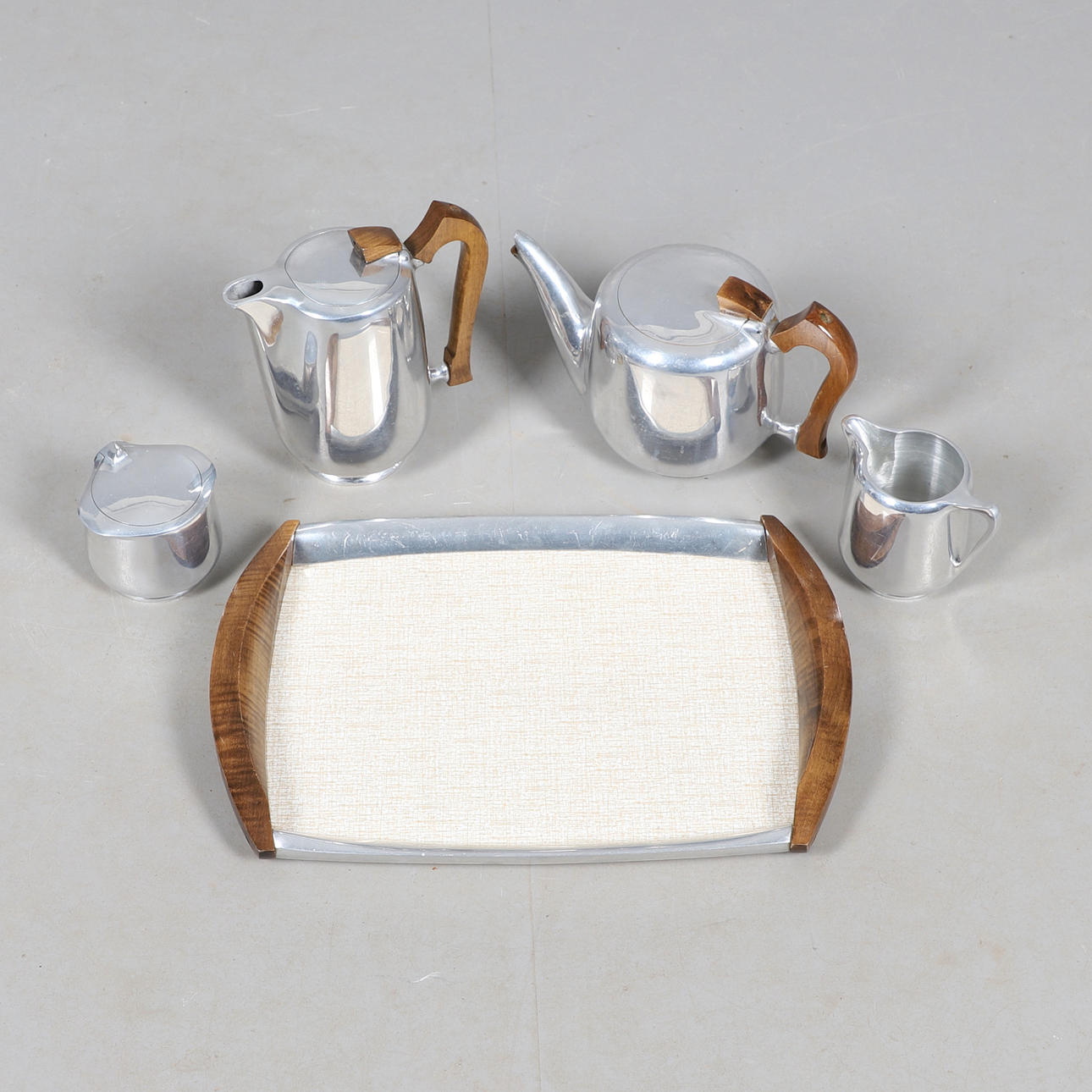 A PICQUOT WARE FIVE PIECE TEA SET.