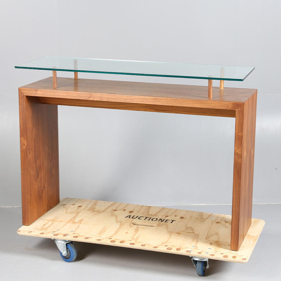 A MODERN GLASS TOPPED CONSOLE TABLE.