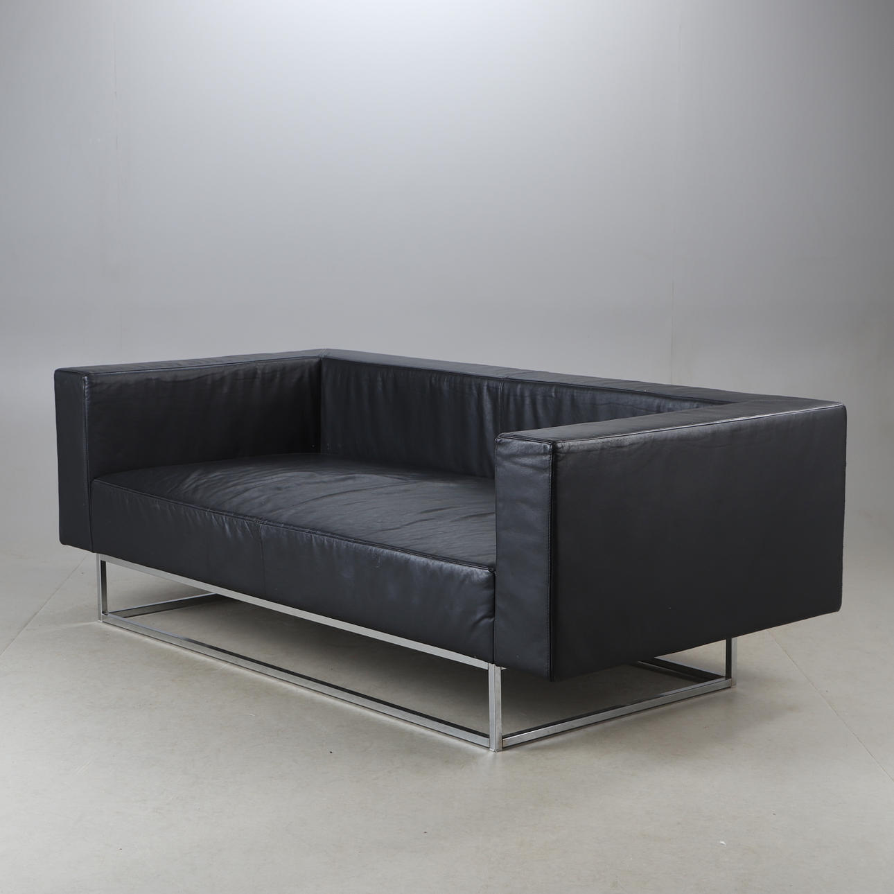 A 21st-century leather upholstered sofa.