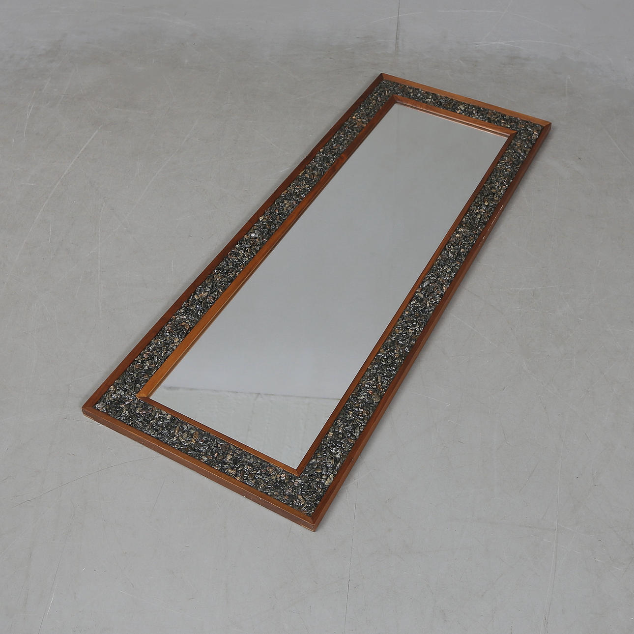 A 1970's stained walnut mirror with stone inlay.