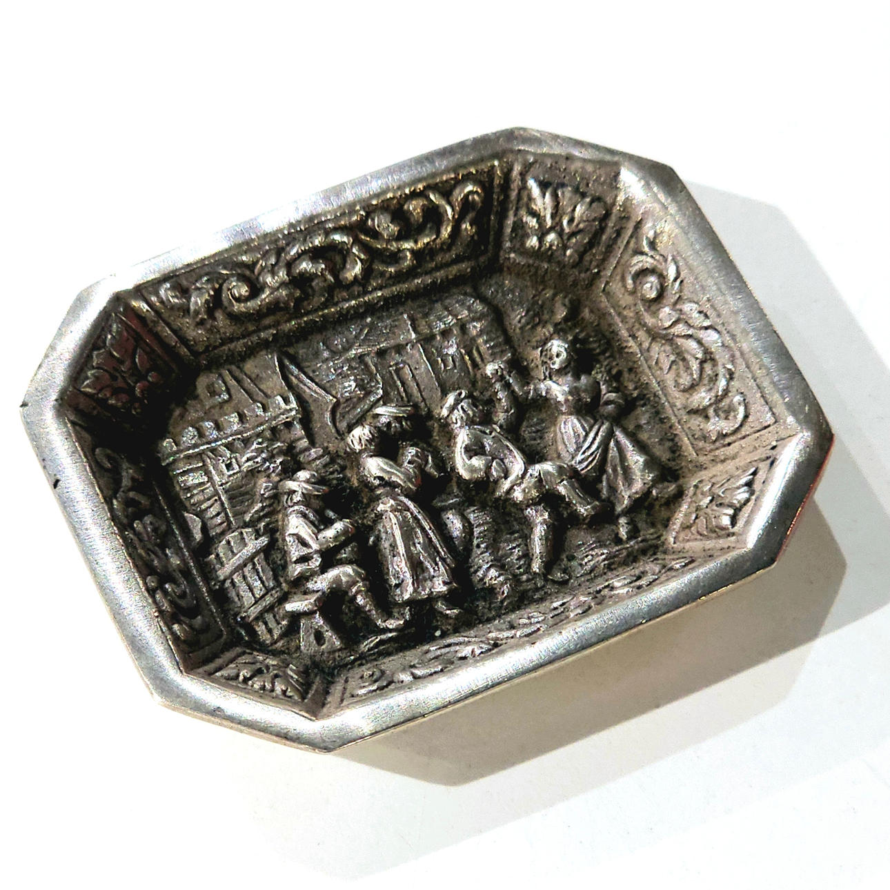 Miniature silver display case with costume scene.