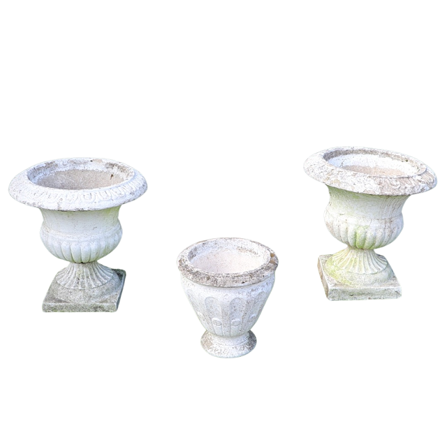 A PAIR OF WHITE PAINTED CONCRETE URNS AND ANOTHER SMALLER.