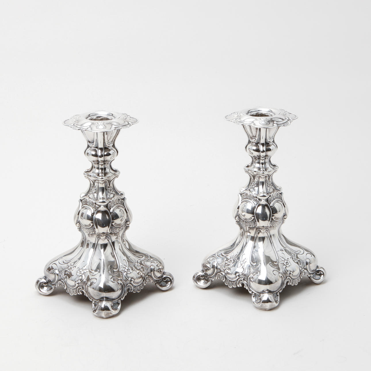 A pair of silver rococo candlesticks, GAB, 1950.