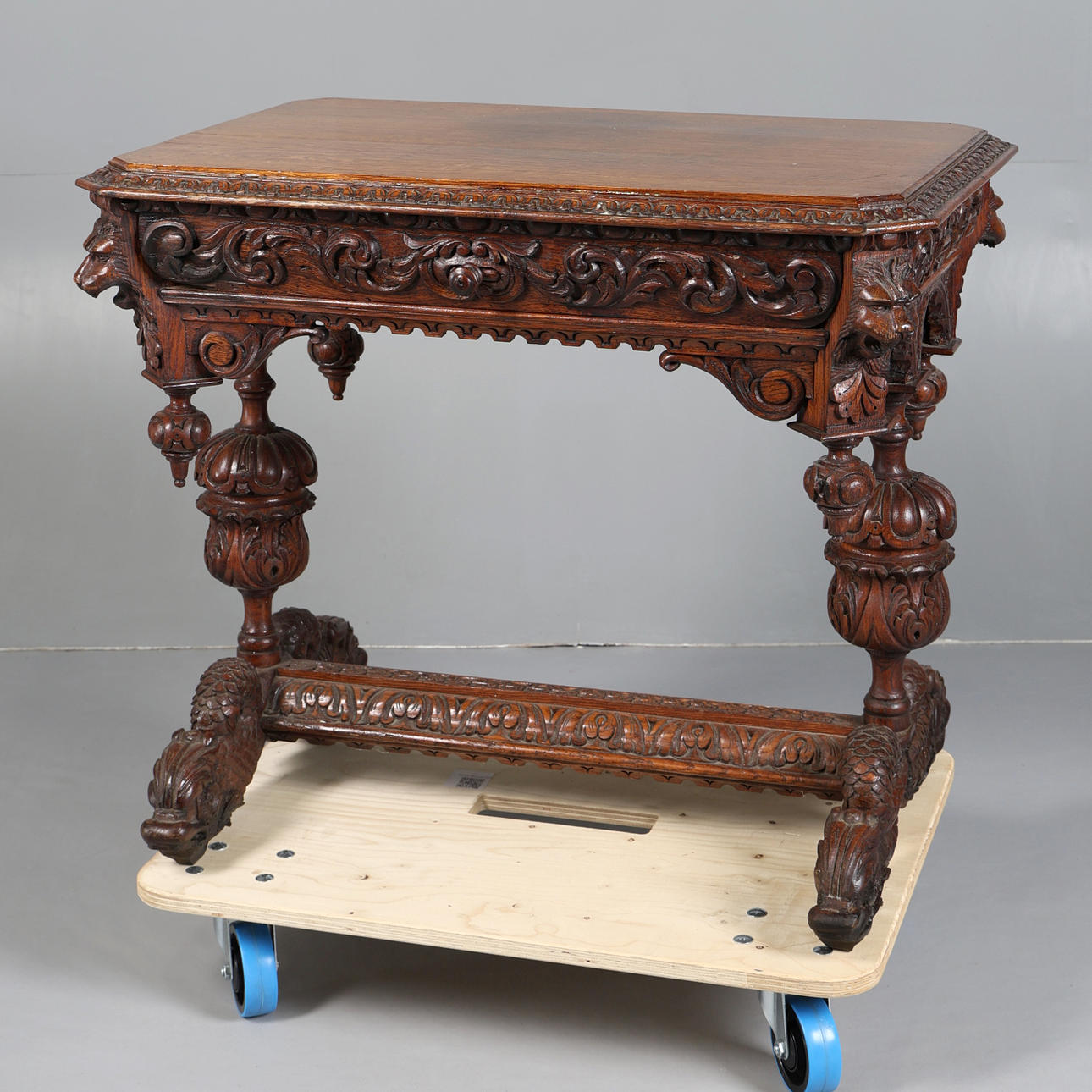 A VICTORIAN HEAVILY CARVED OAK CENTRE TABLE.