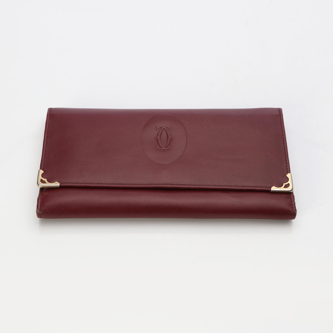 CARTIER, CARTERA VINTAGE. Piel burdeos.