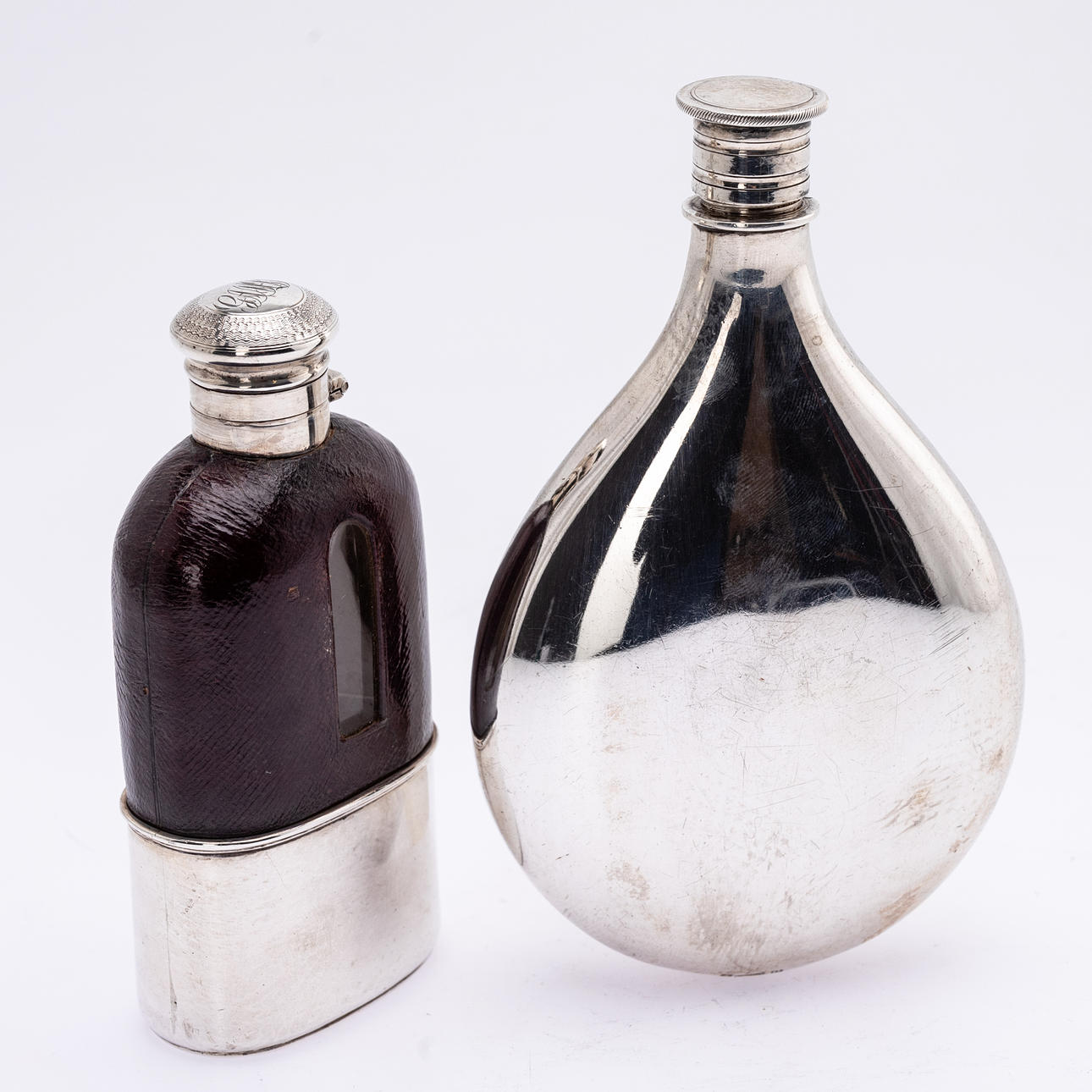 COLEN HEWER CHESHIRE U.A. Two different hip flasks, sterling silver, Birmingham 1863 and 1883 (2).