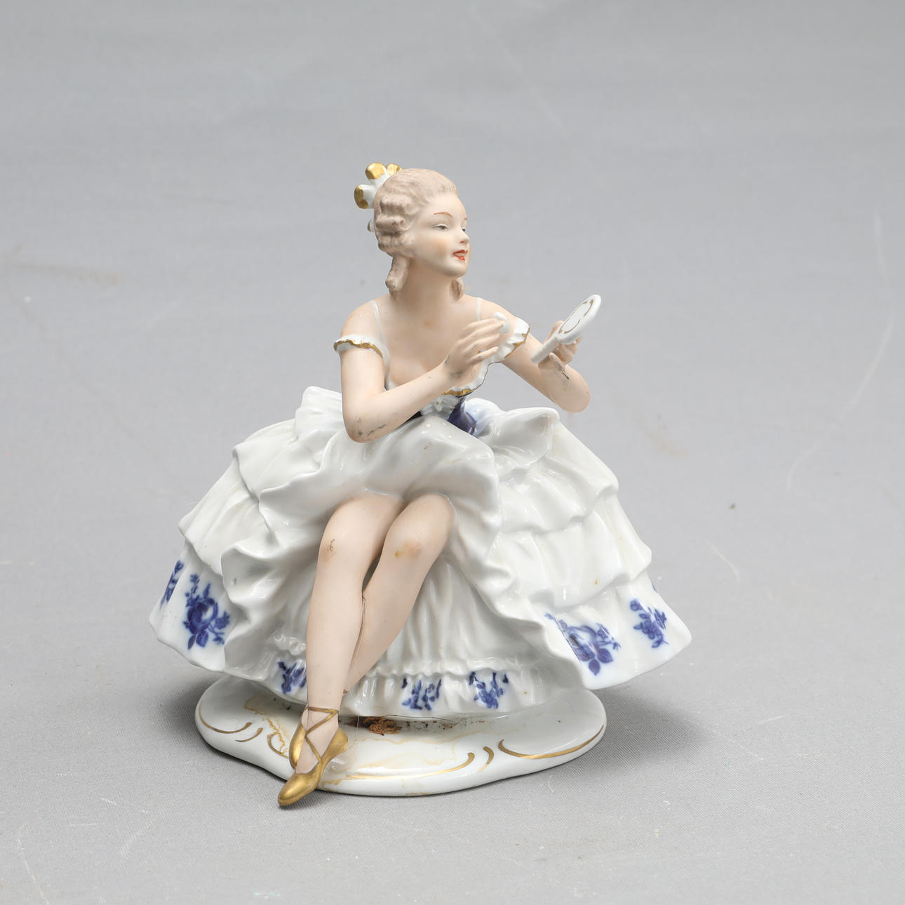 A porcelain figurine marked 1764 Germany.