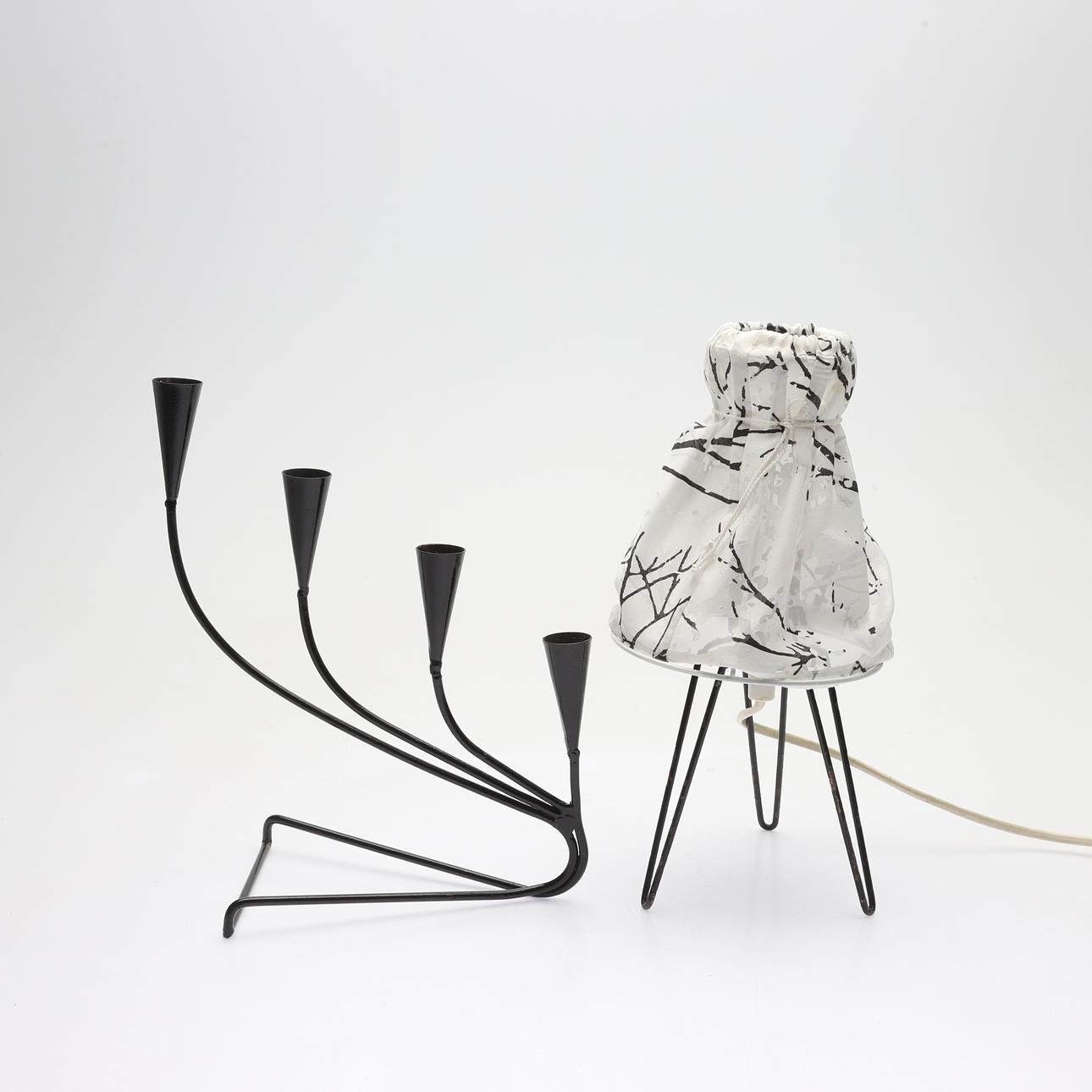 A metal string table lamp and candlestick, 20th century.