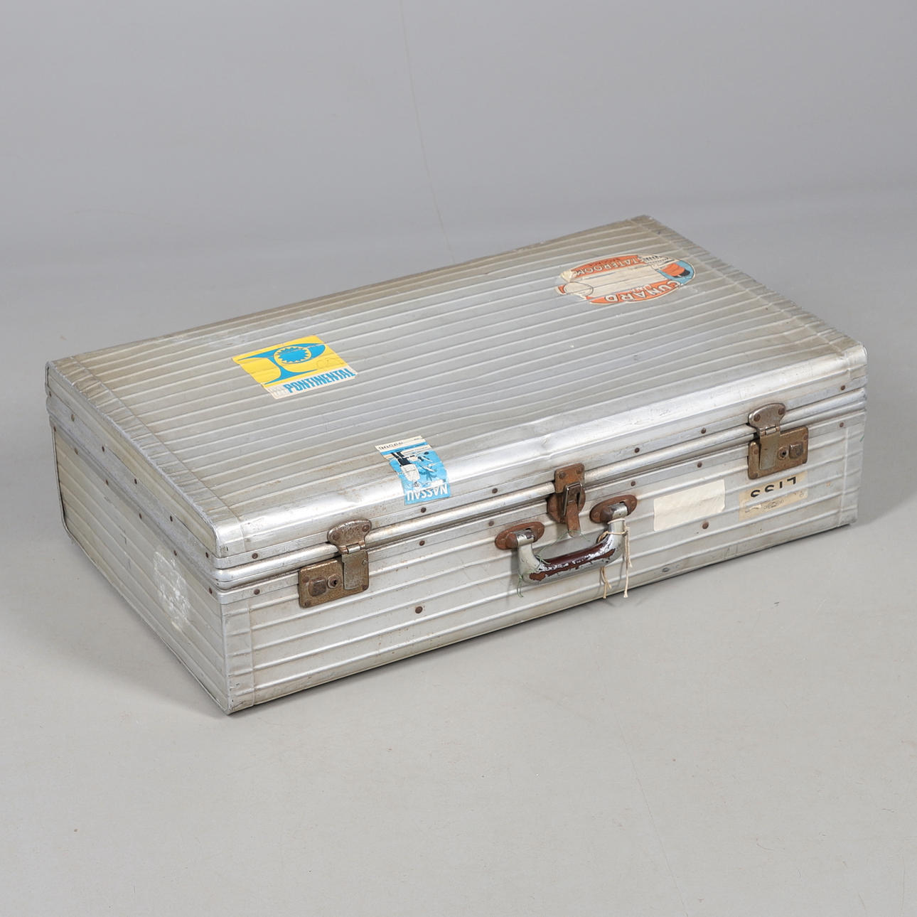 A VINTAGE RIMOWA SUITCASE.