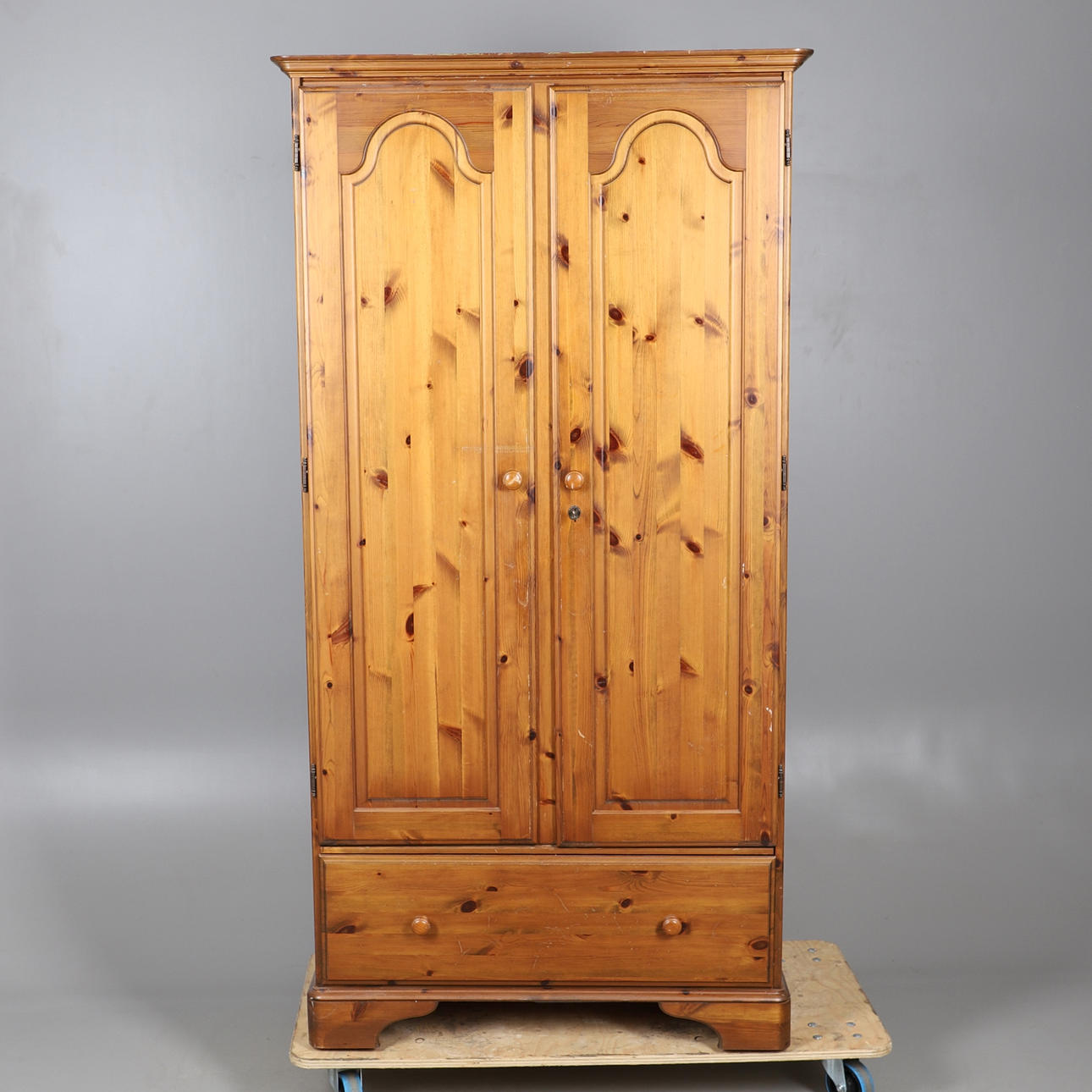A MODERN DUCAL PINE WARDROBE.