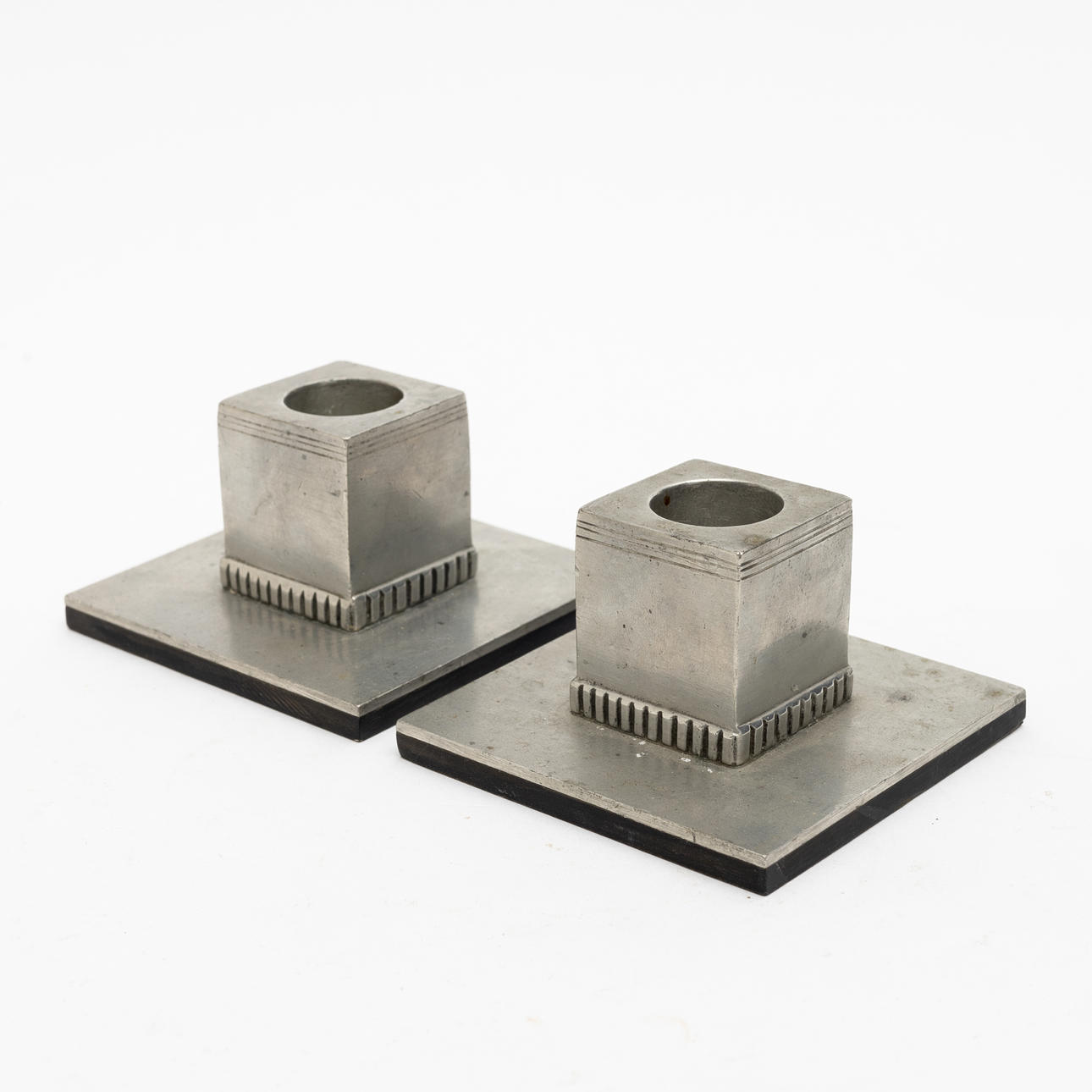 A pair of candlesticks, tin and bakelt.