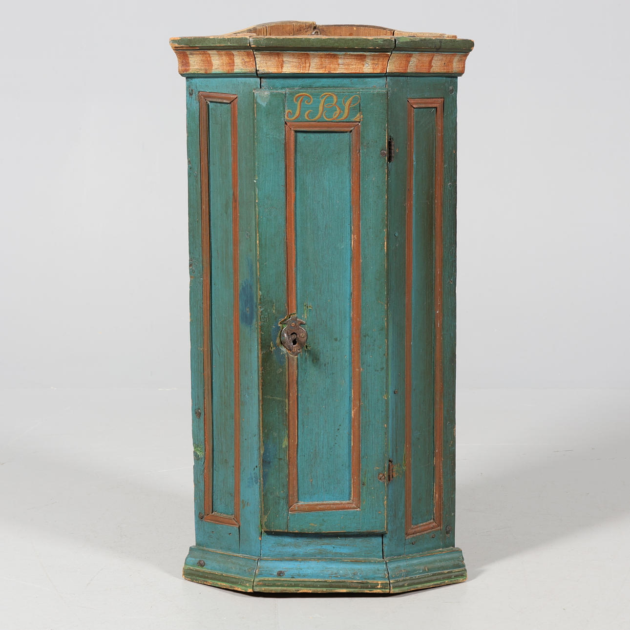 A corner cupboard, 1700/19th century, painted.