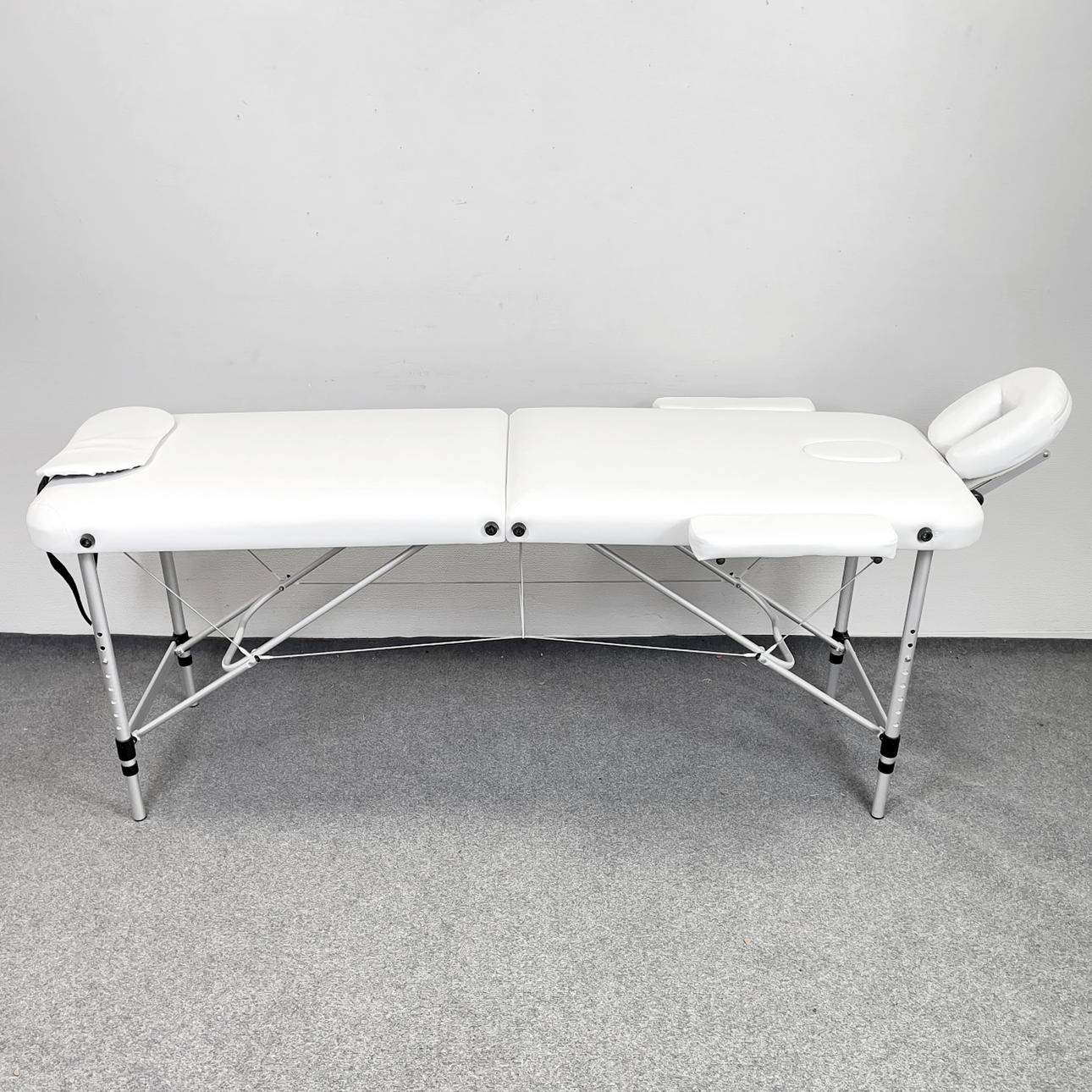 A massage bench, portable/foldable in a bag, 2000's.