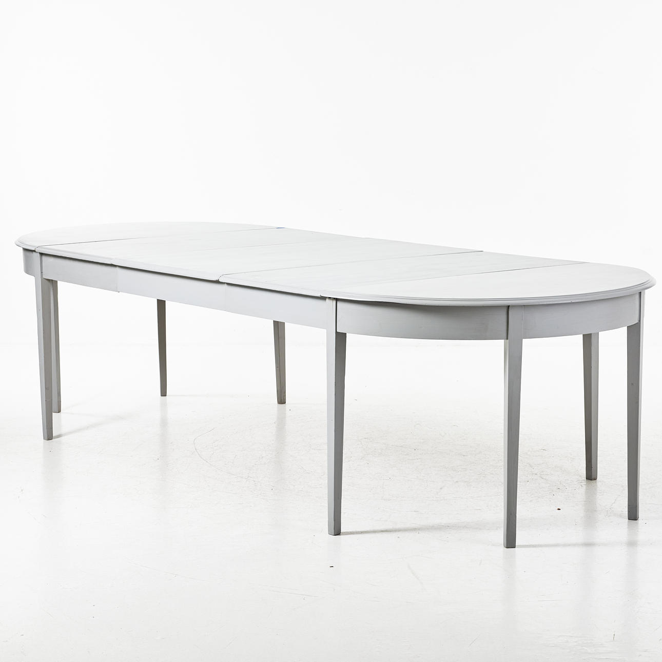 A late 19th century dining table, painted, profiled edge.