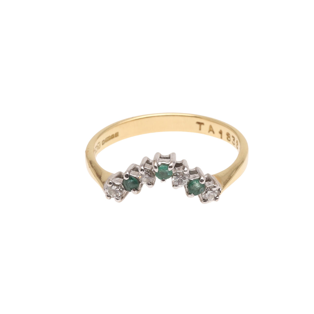 AN EMERALD AND DIAMOND V-SHAPED RING.