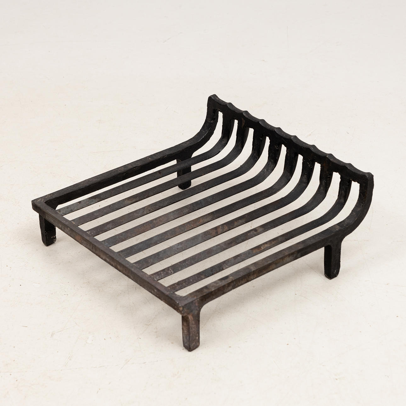A cast iron fireplace grate, 20th century.