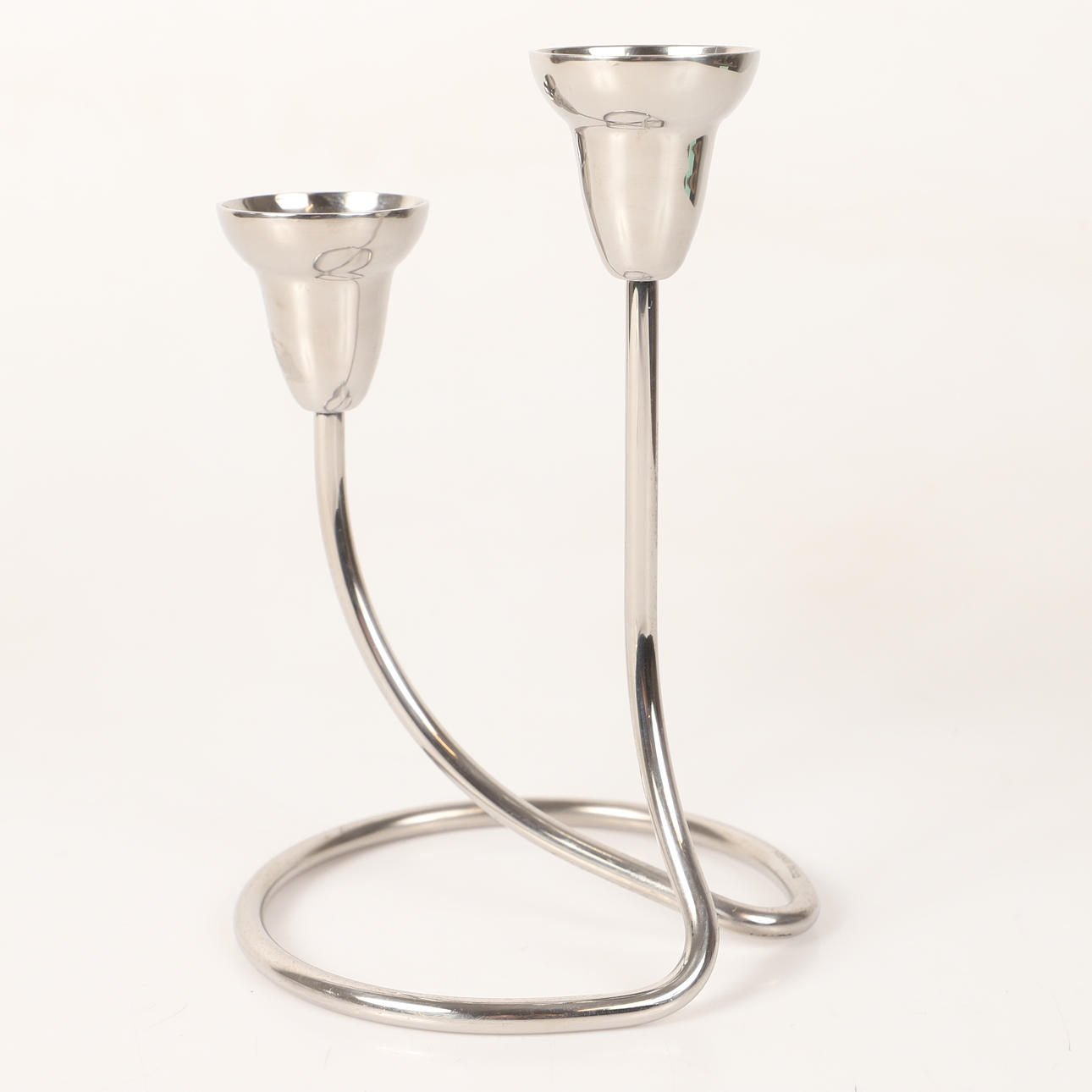 Candlestick, “Swing”, stainless steel, Georg Jensen, Denmark.