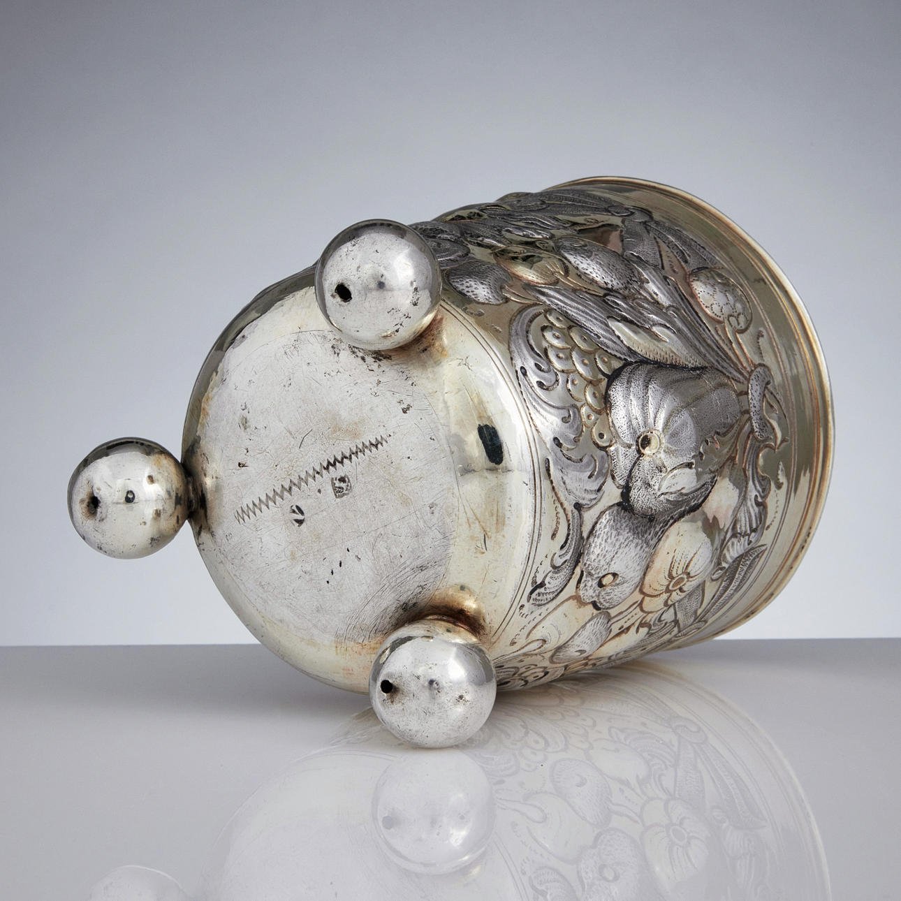 HANS HIRTZ. A parcel gilt silver beaker on ball feet, mark of Hans