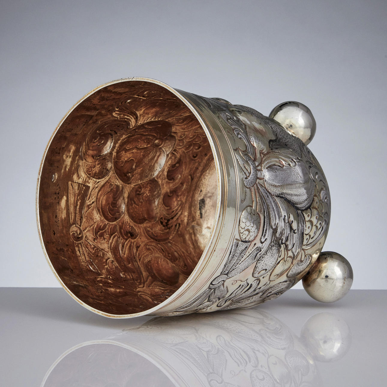 HANS HIRTZ. A parcel gilt silver beaker on ball feet, mark of Hans