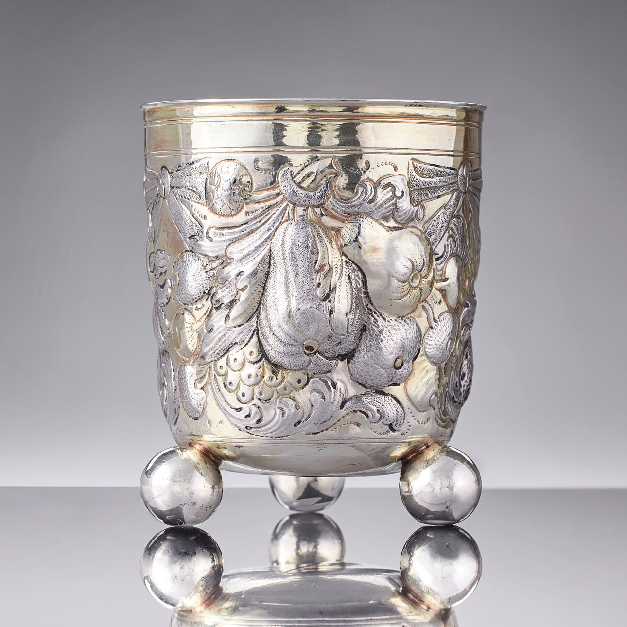 HANS HIRTZ. A parcel gilt silver beaker on ball feet, mark of Hans