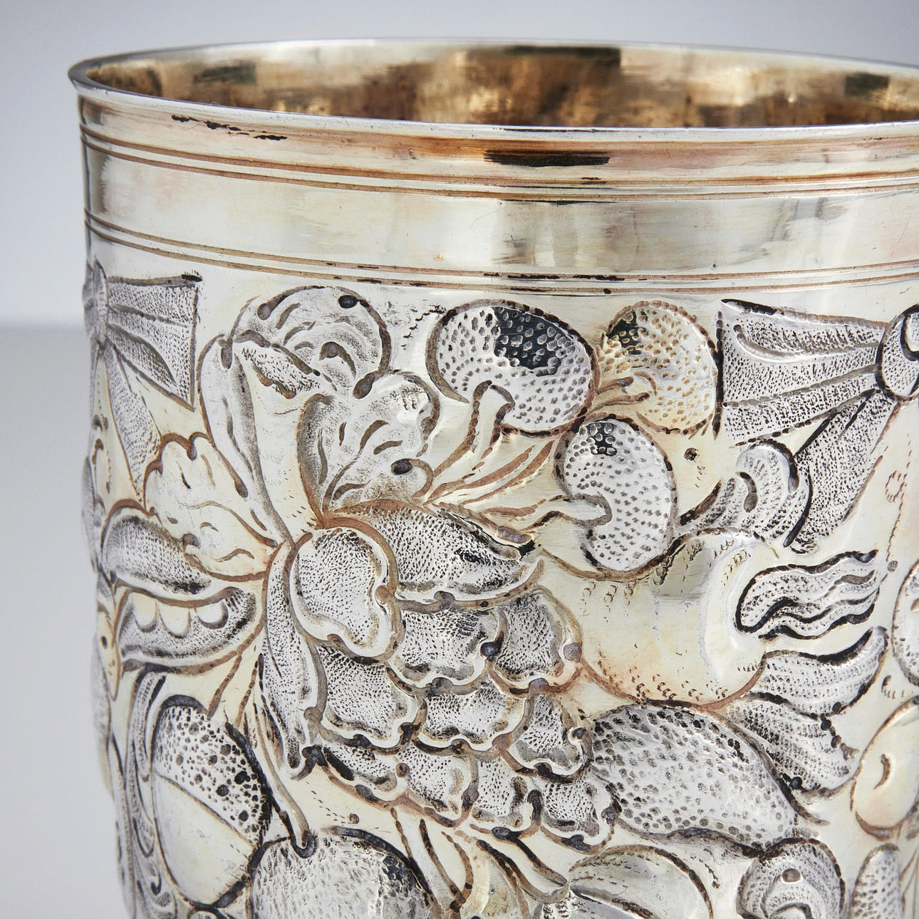 HANS HIRTZ. A parcel gilt silver beaker on ball feet, mark of Hans