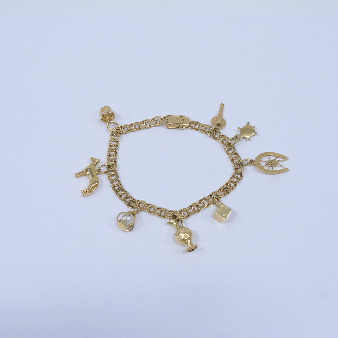 ARMBAND MED BERLOCKER, BISMARCK, 18K GULD.