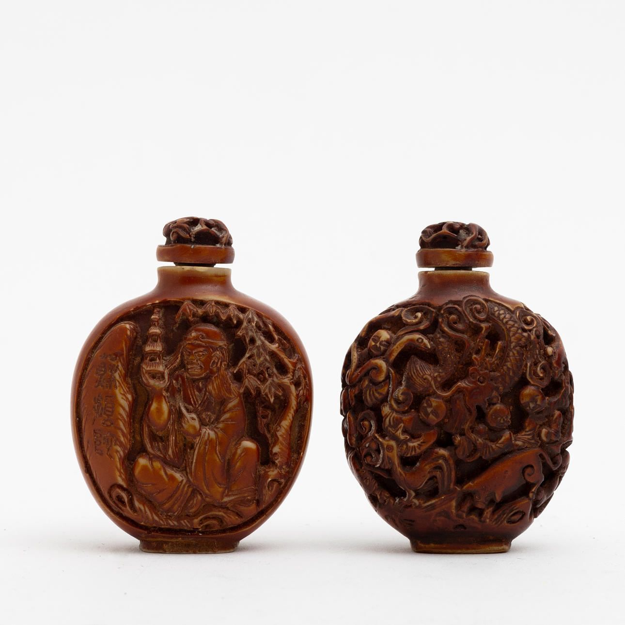 Two Chinese bone snuff bottles, 20th century.