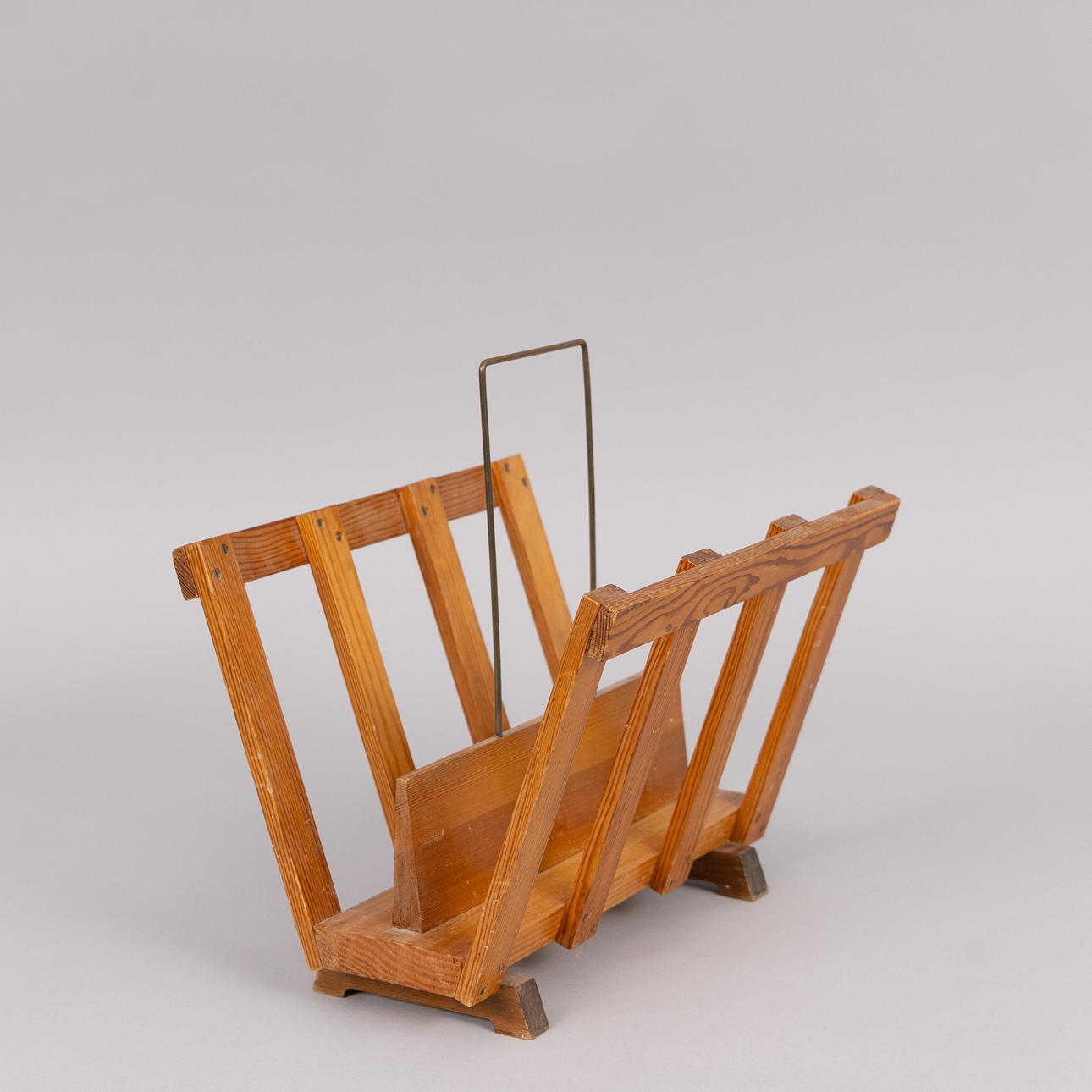 A pine magazine cradle, 20th century.