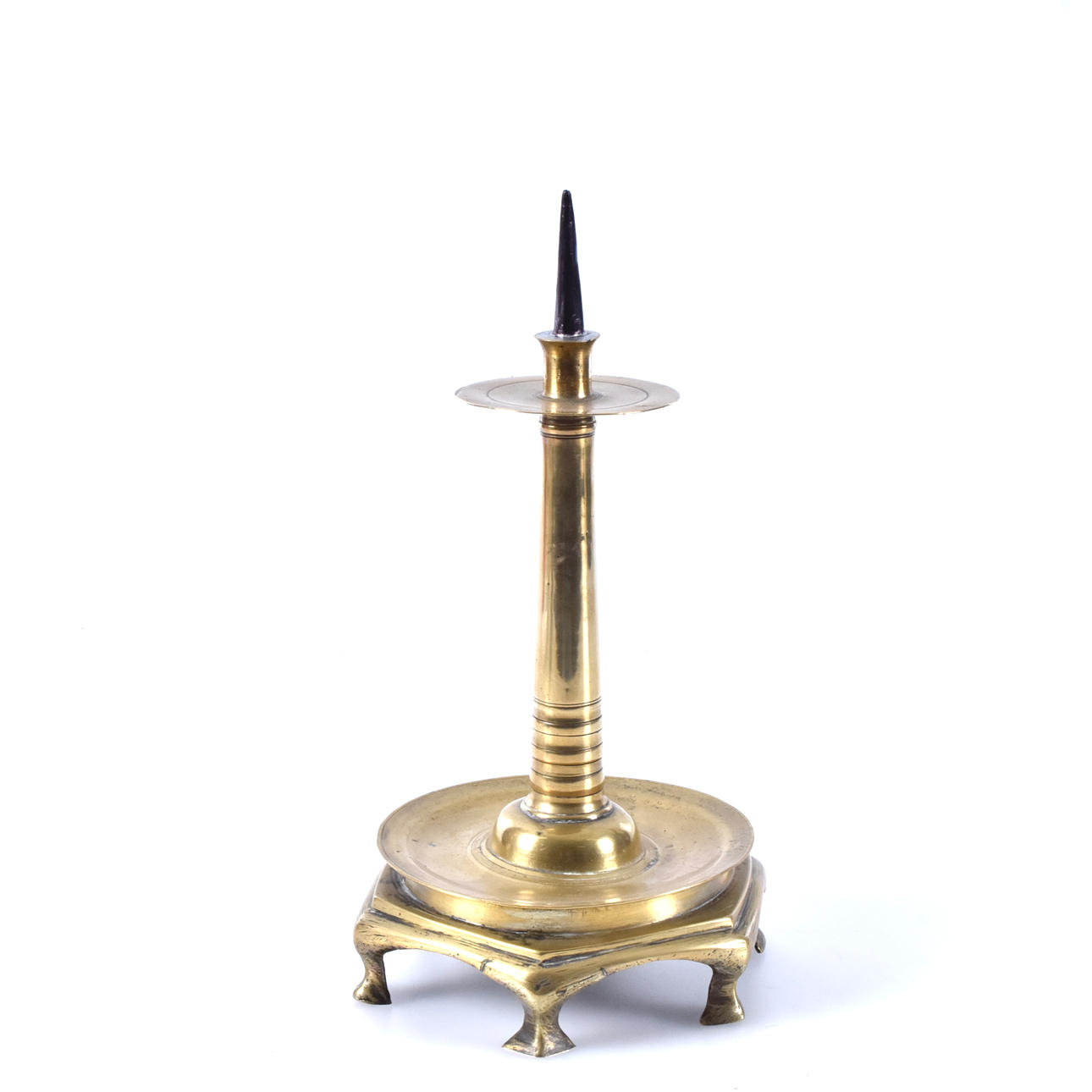 A brass candlestick, 16th century.