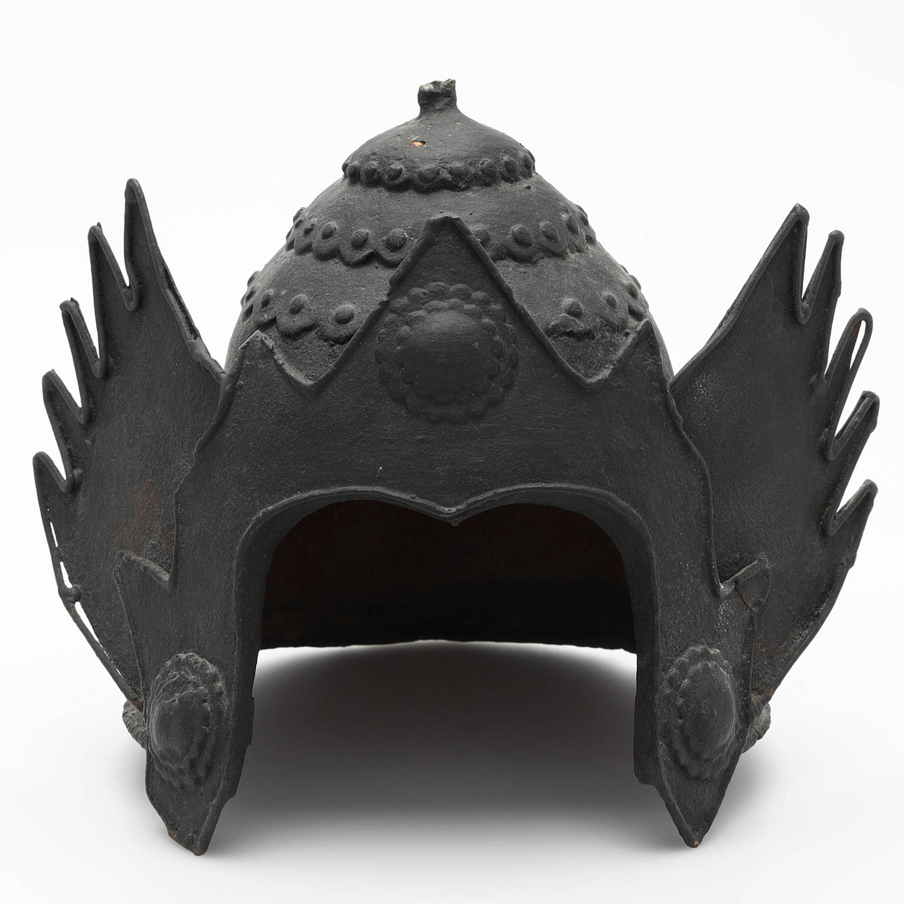 Ein skulpturaler Helm aus Metallguss.