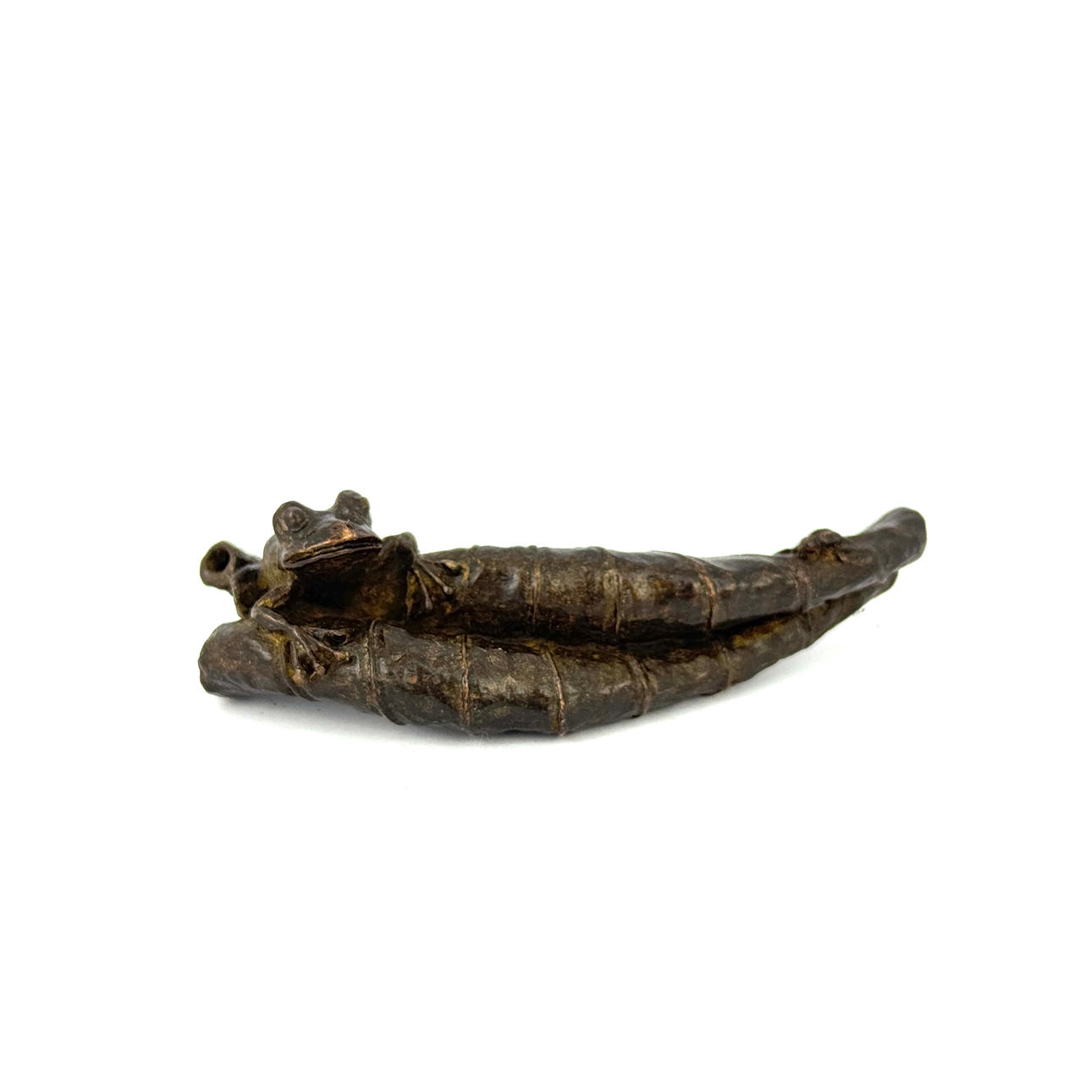 BRONZE FROG ON A LEAF.