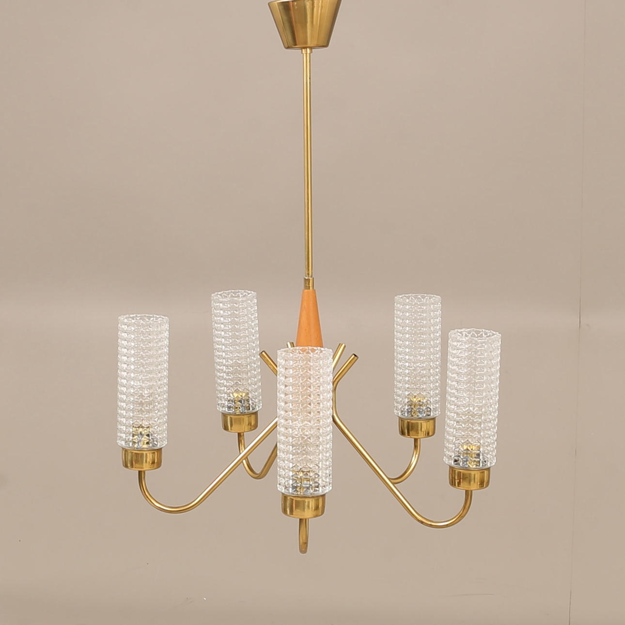 A 1960's teak and brass ceiling lamp.