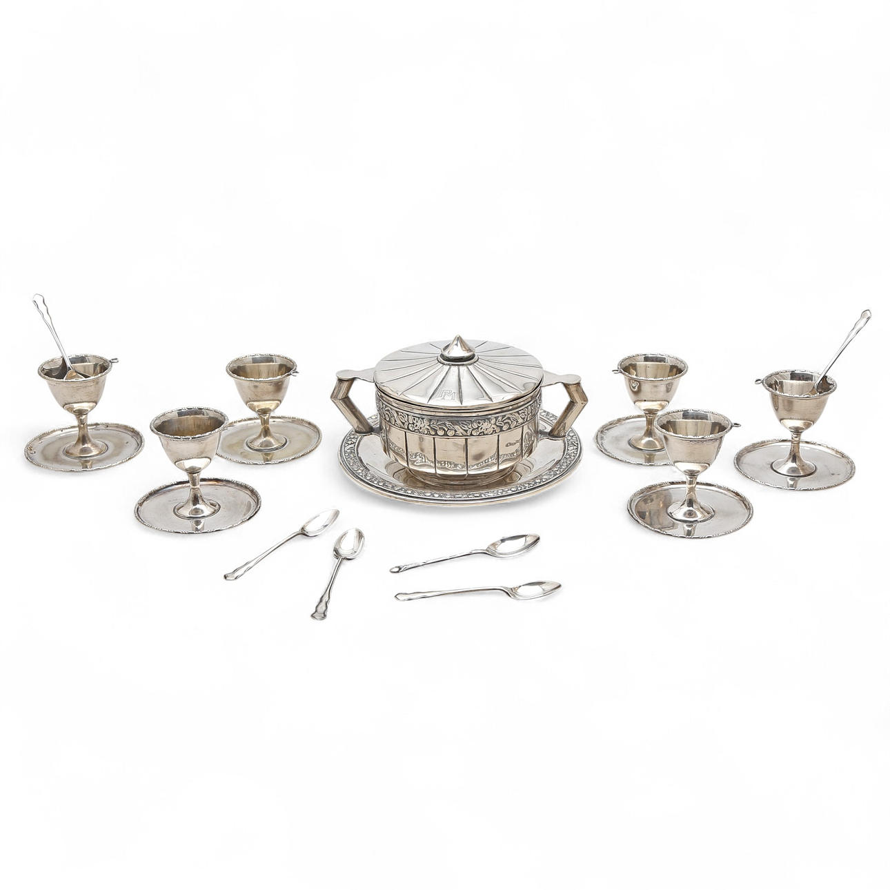 Set of egg cups with spoons and sugar bowl with lid and plate in silver metal, from the second quarter of the 20th century.