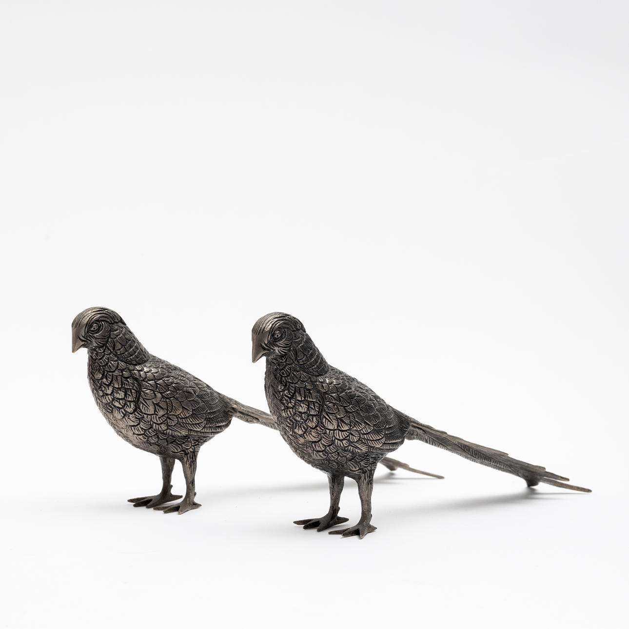 A pair of light metal table decorations, Peacocks.