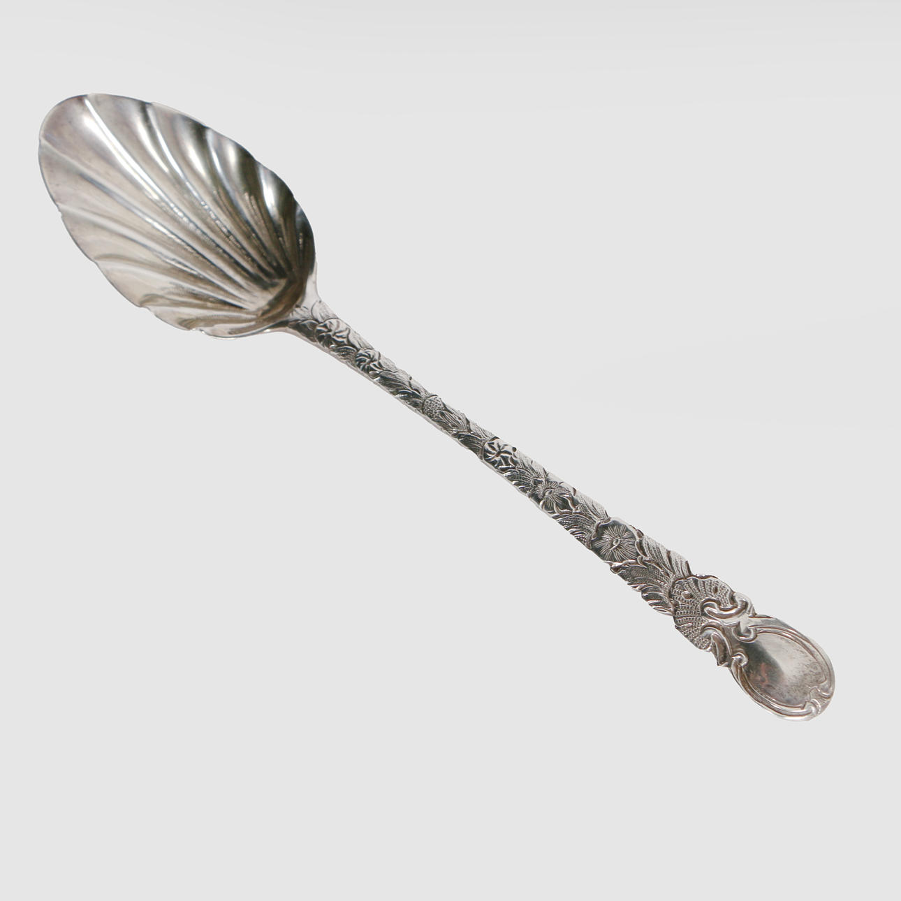 A GEORGE III SILVER SCALLOPED DESSERT SPOON.
