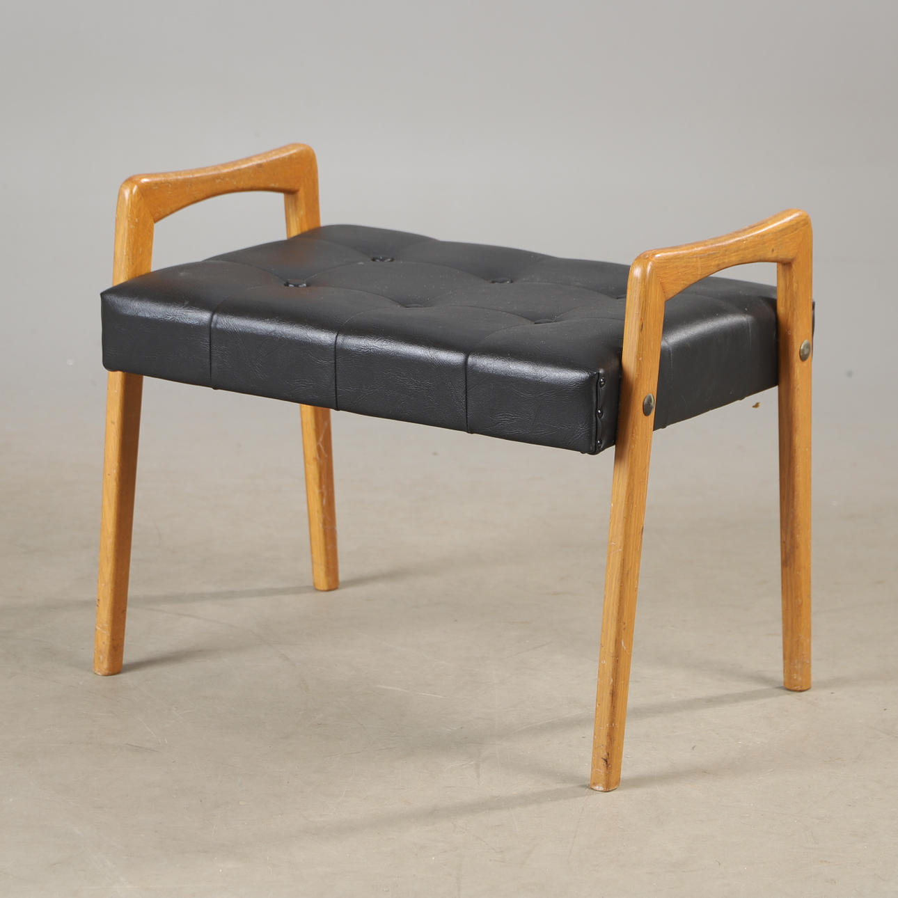 An oak/artificial leather stool, 1960s.