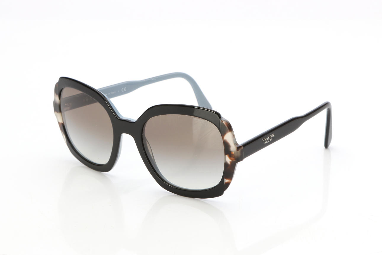 PRADA, SUNGLASSES. Black/grey plastic with tortoiseshell details.