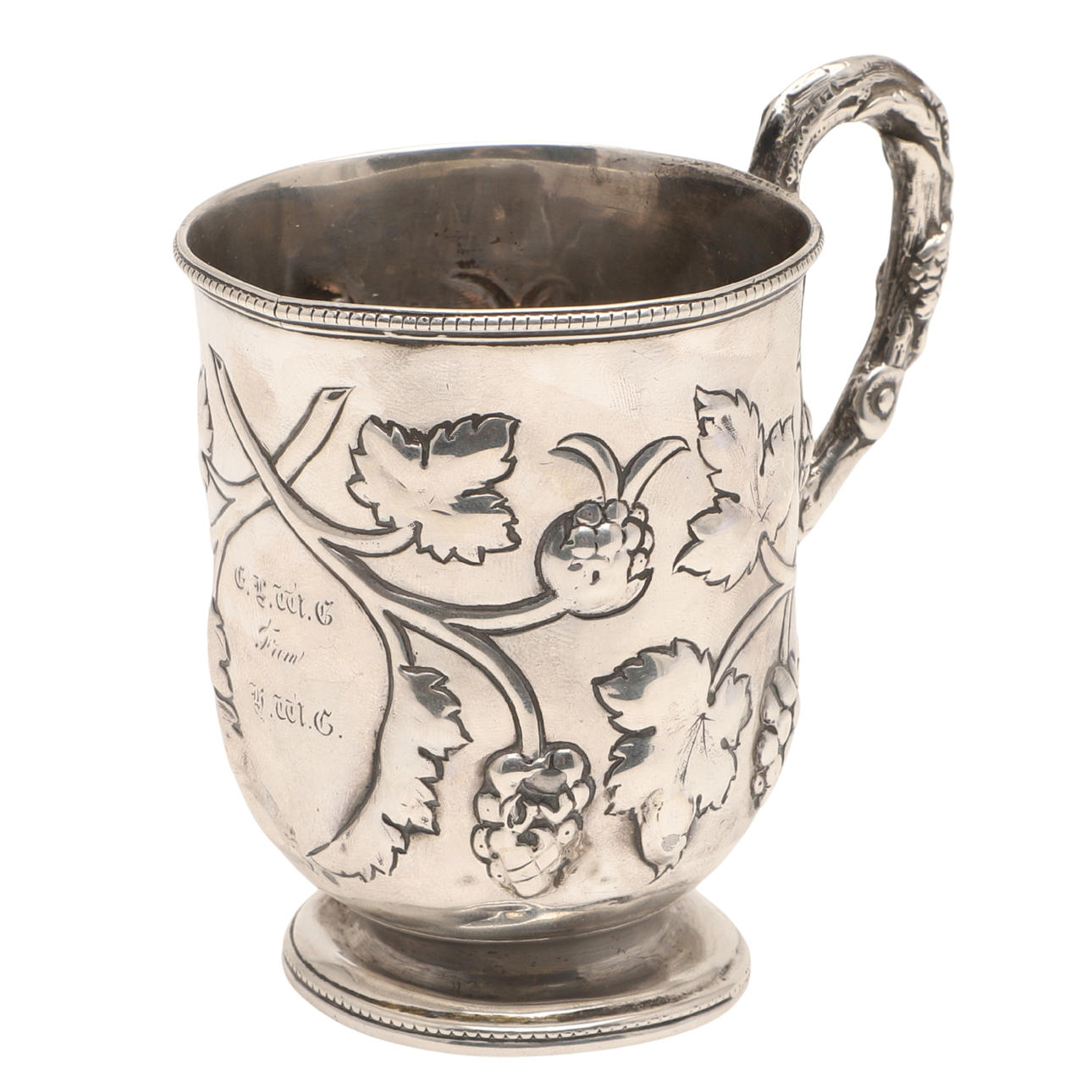 A VICTORIAN SILVER EMBOSSED MUG.