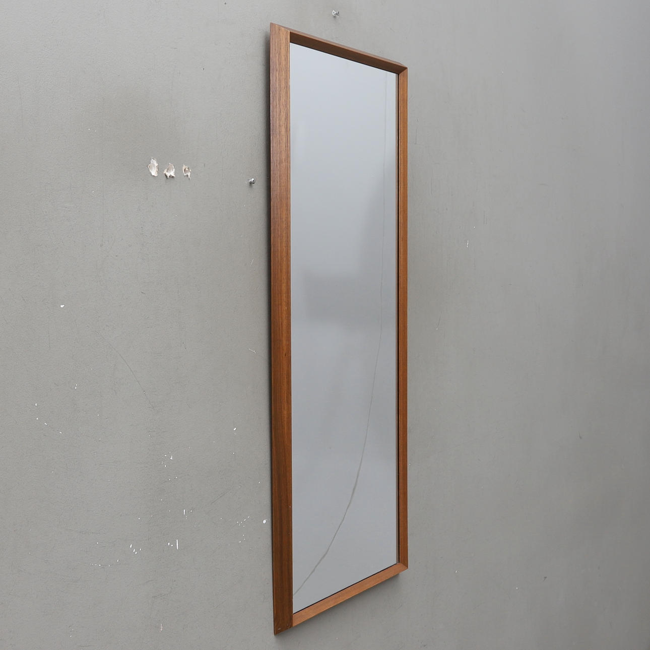 A 20th century teak veneer mirror.