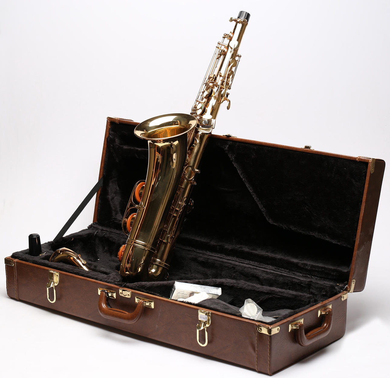 A brass saxophone, Thomson, in bag.