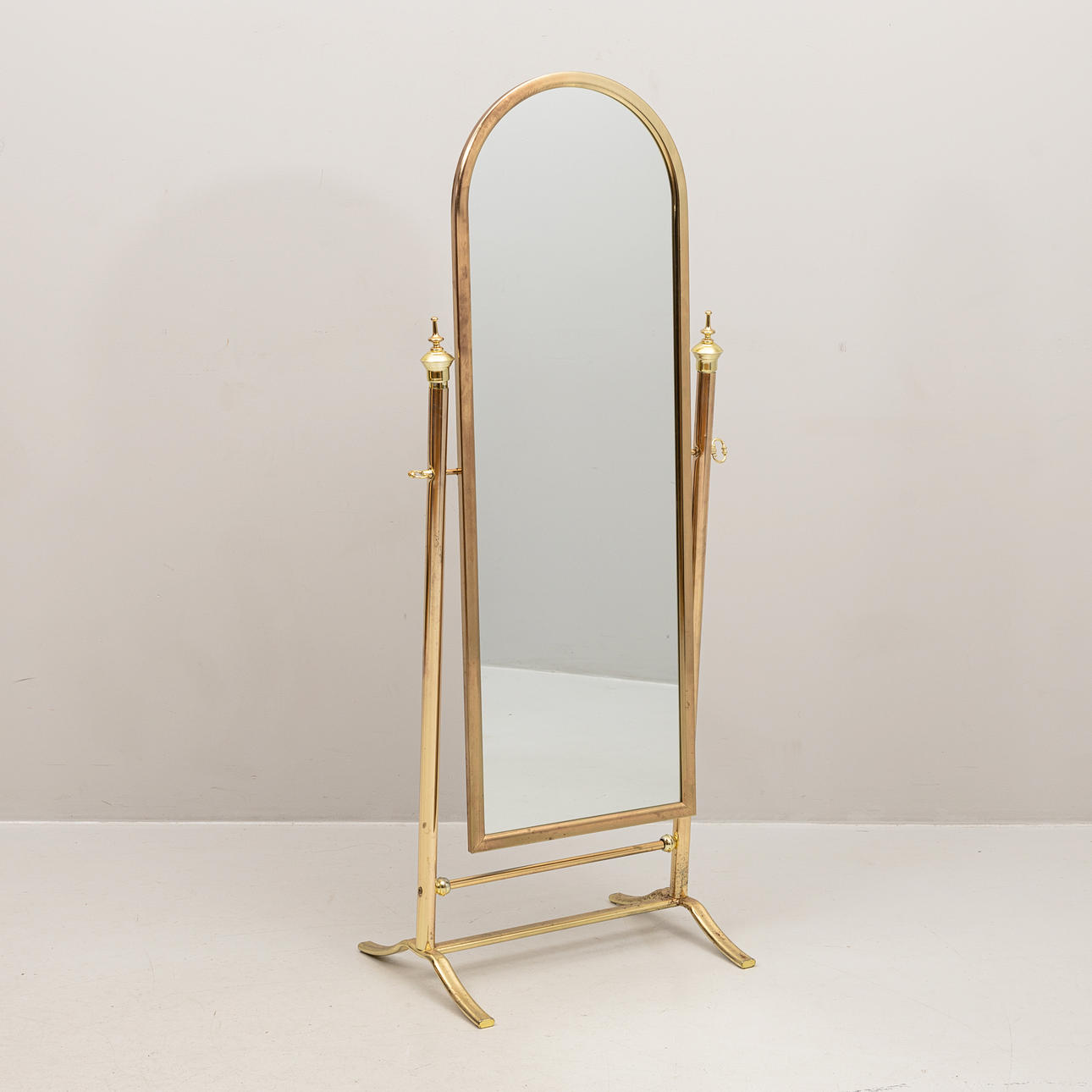 A 20th century brass floor mirror.