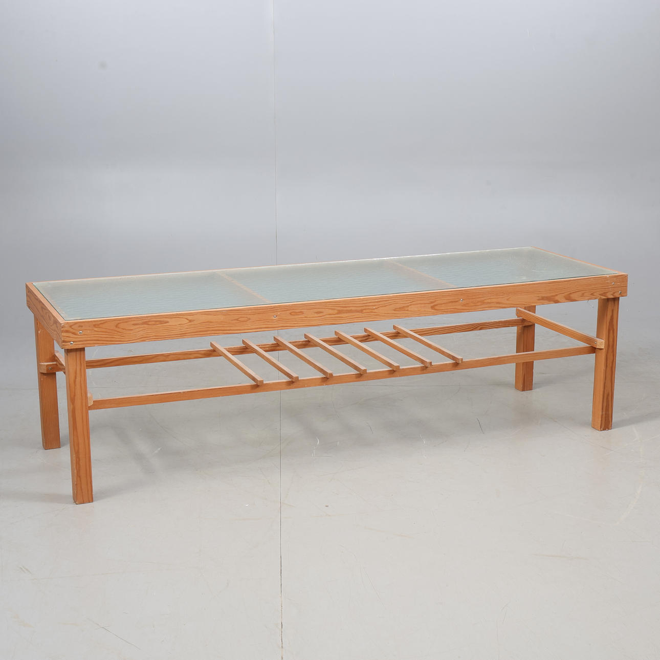 A 20th century pine sideboard with glass top.