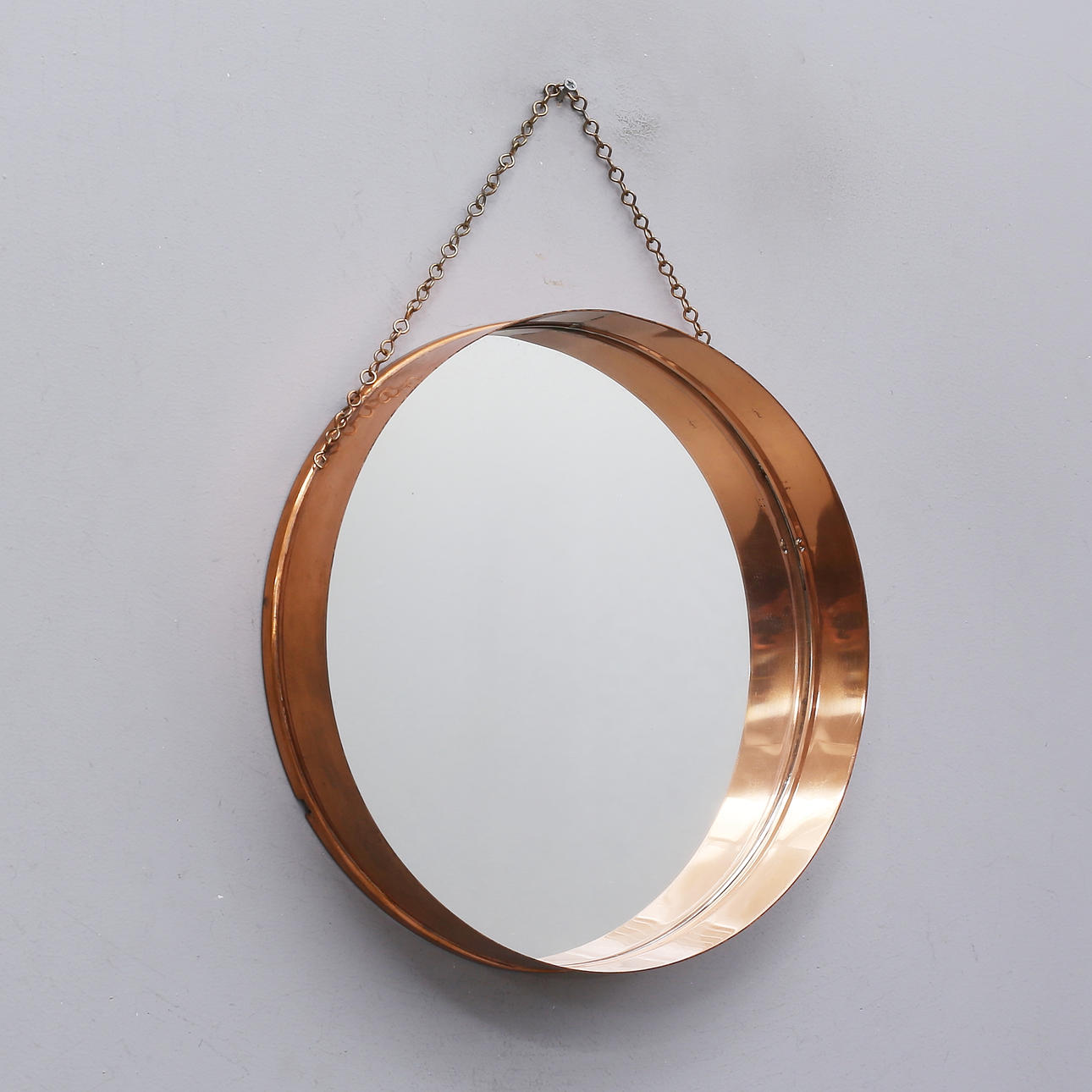A mirror with a copper frame, Panter products, later part of the 20th century.