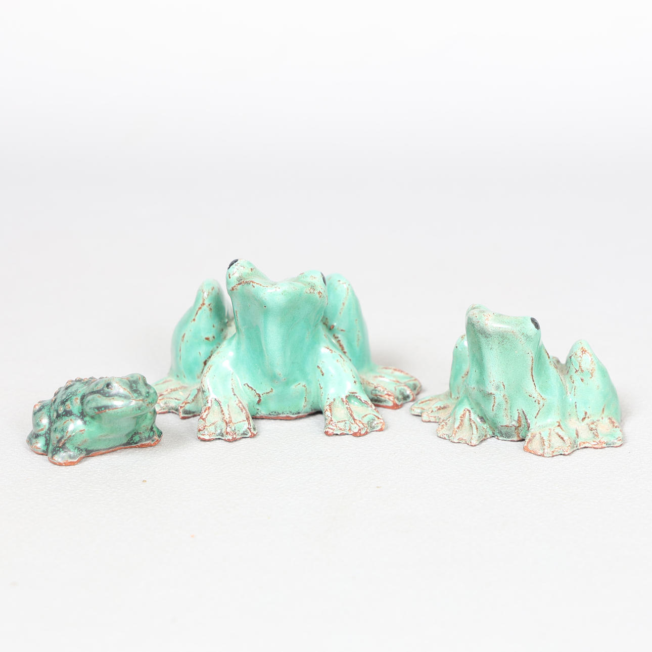 CLIVE BROOKER, TWO STUDIO POTTERY FROGS AND A TOAD (3).