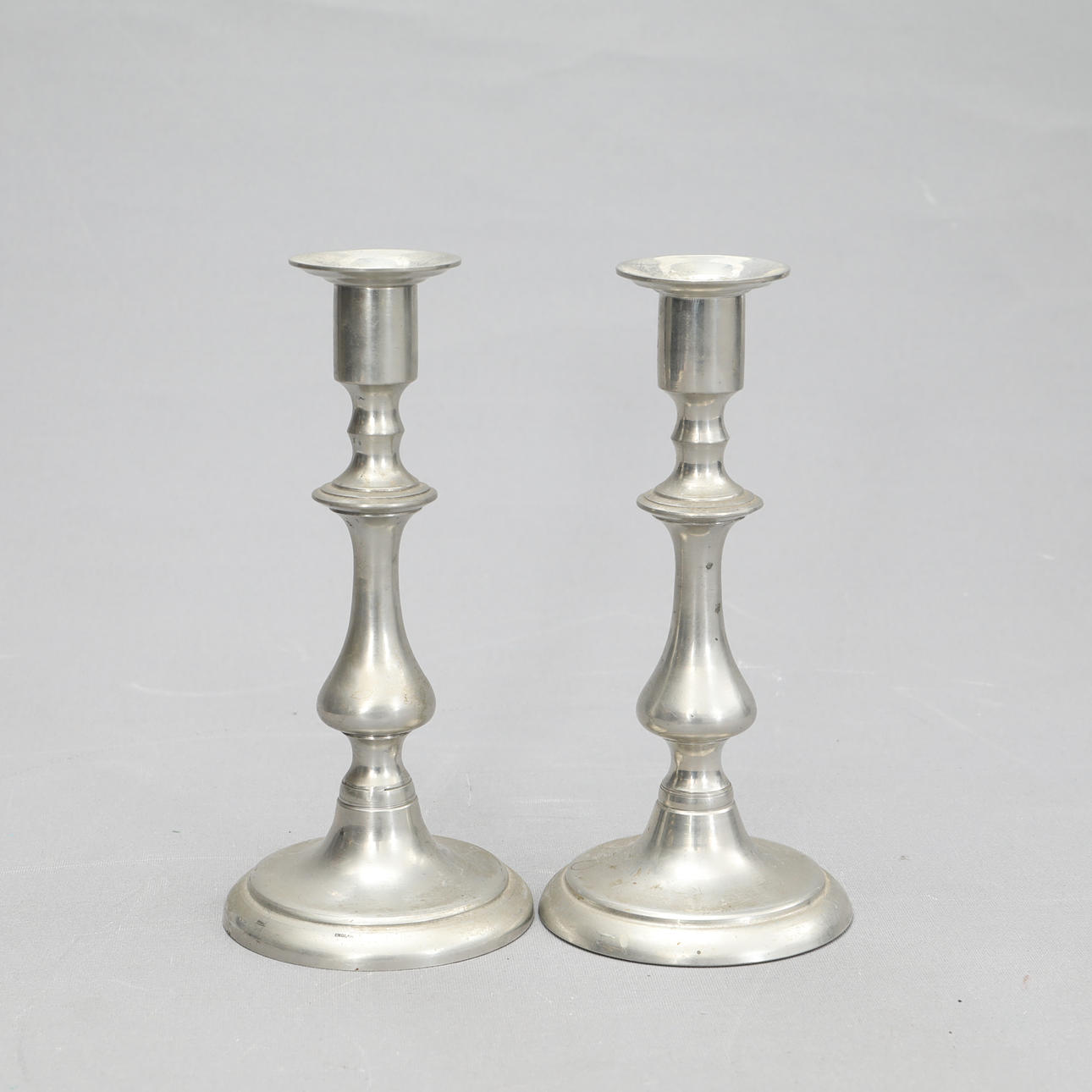 A pair of candlesticks, England.