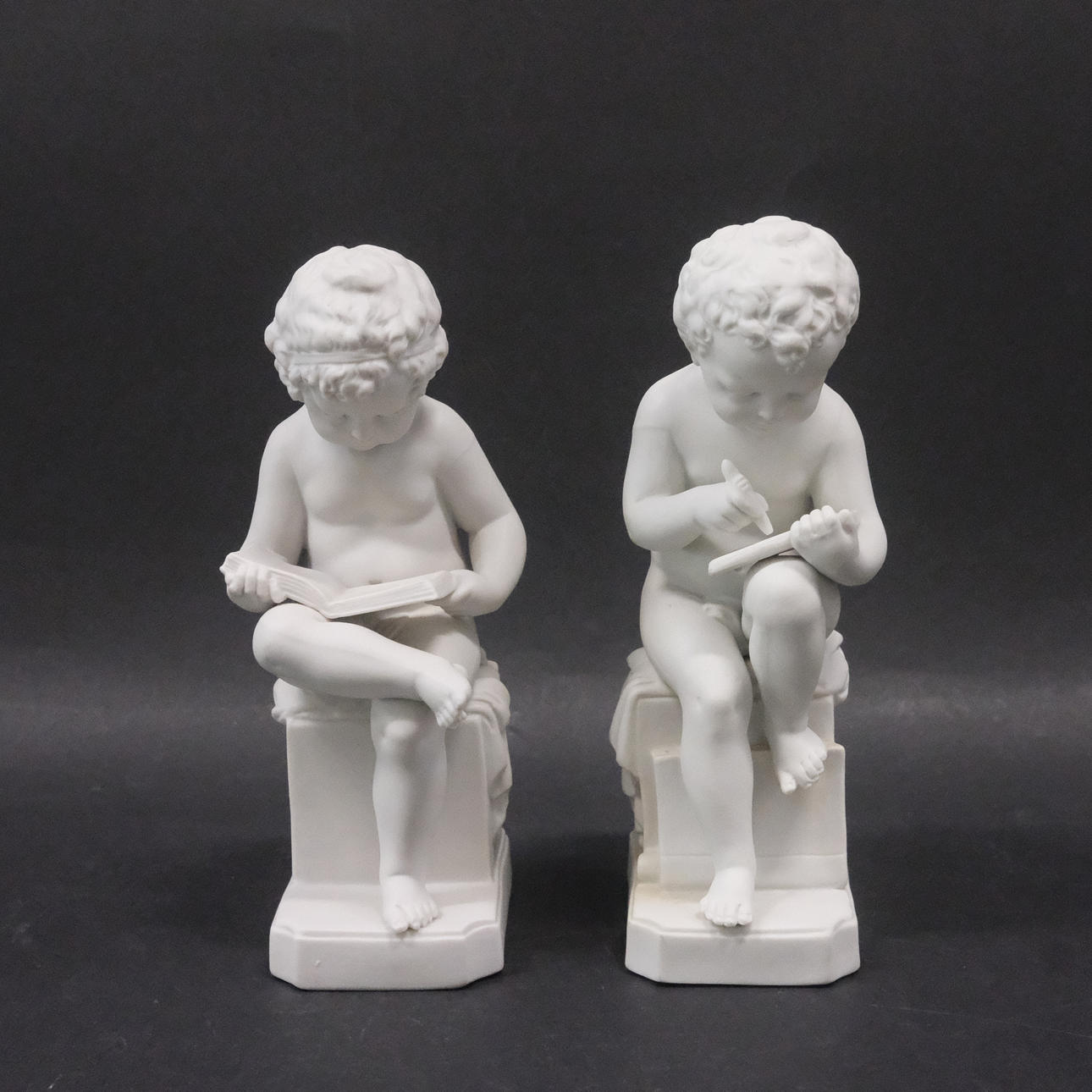 FIGURATIVE BOOKENDS, A PAIR.