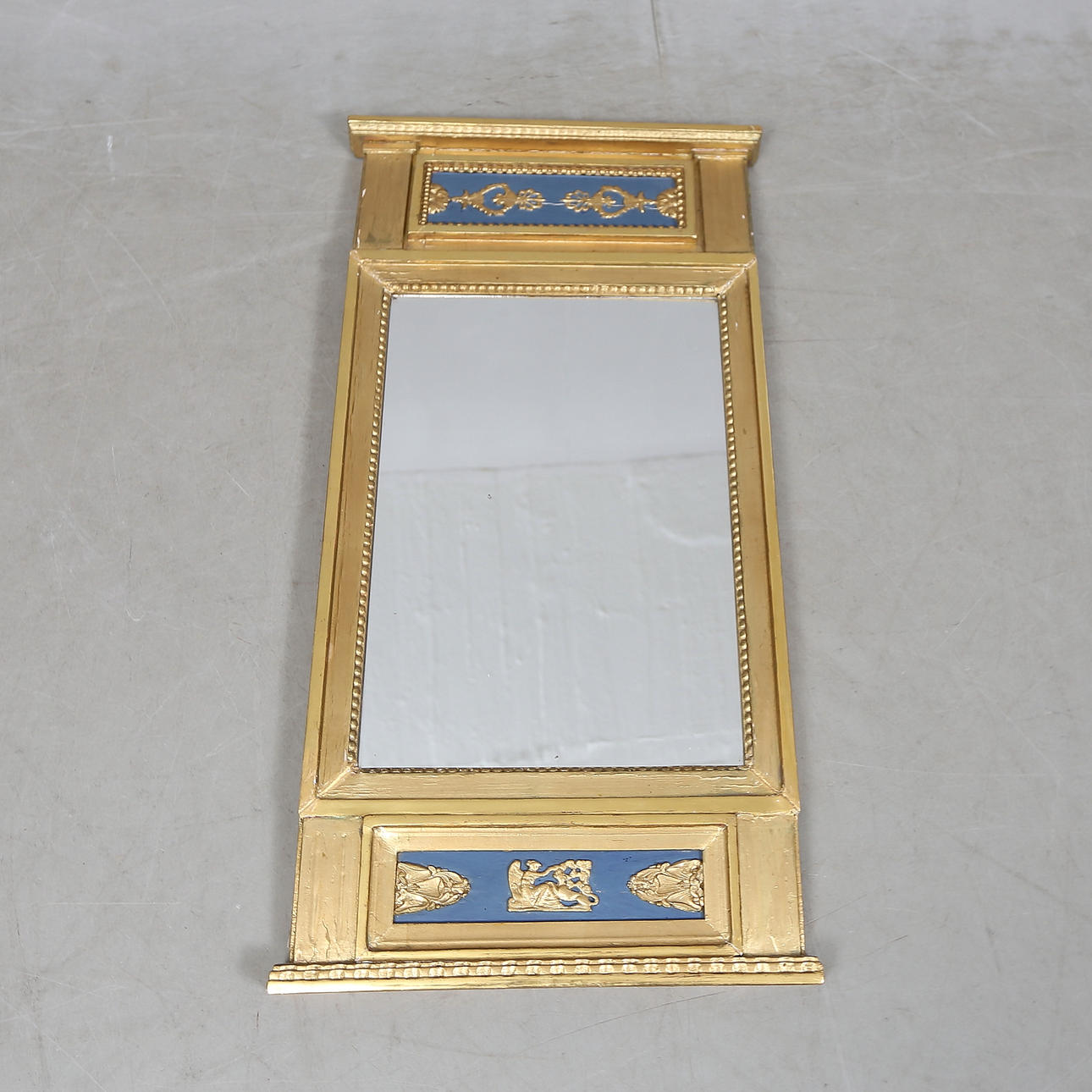 An empire mirror, 19th century.